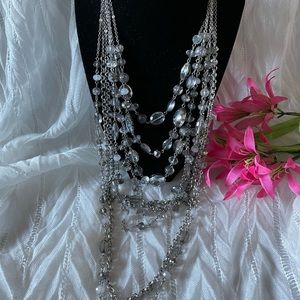 8 strands silver tone Lt acrylic gray color beads. Adjustable necklace